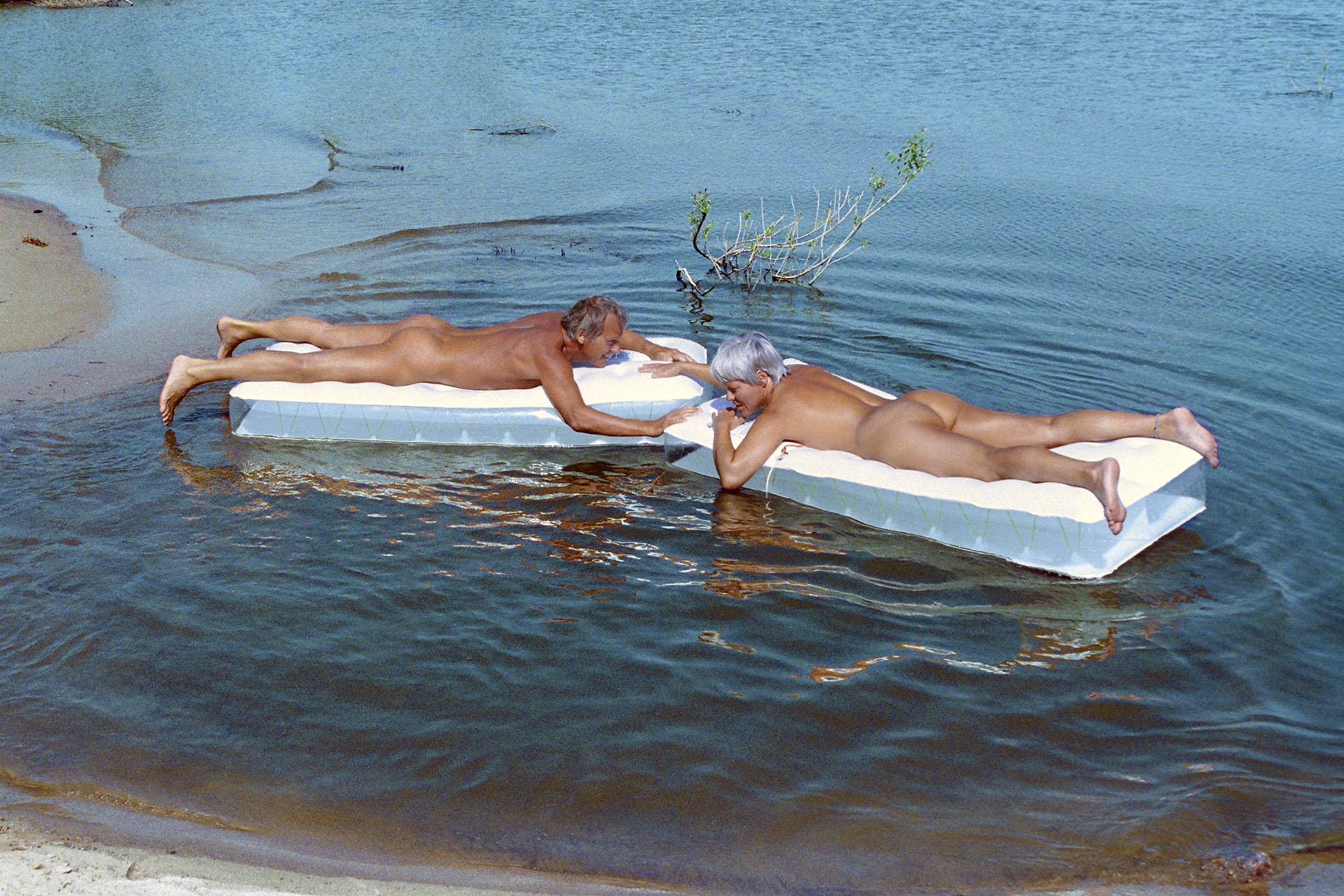 Nudism - naked and free - naked couple sunbathing